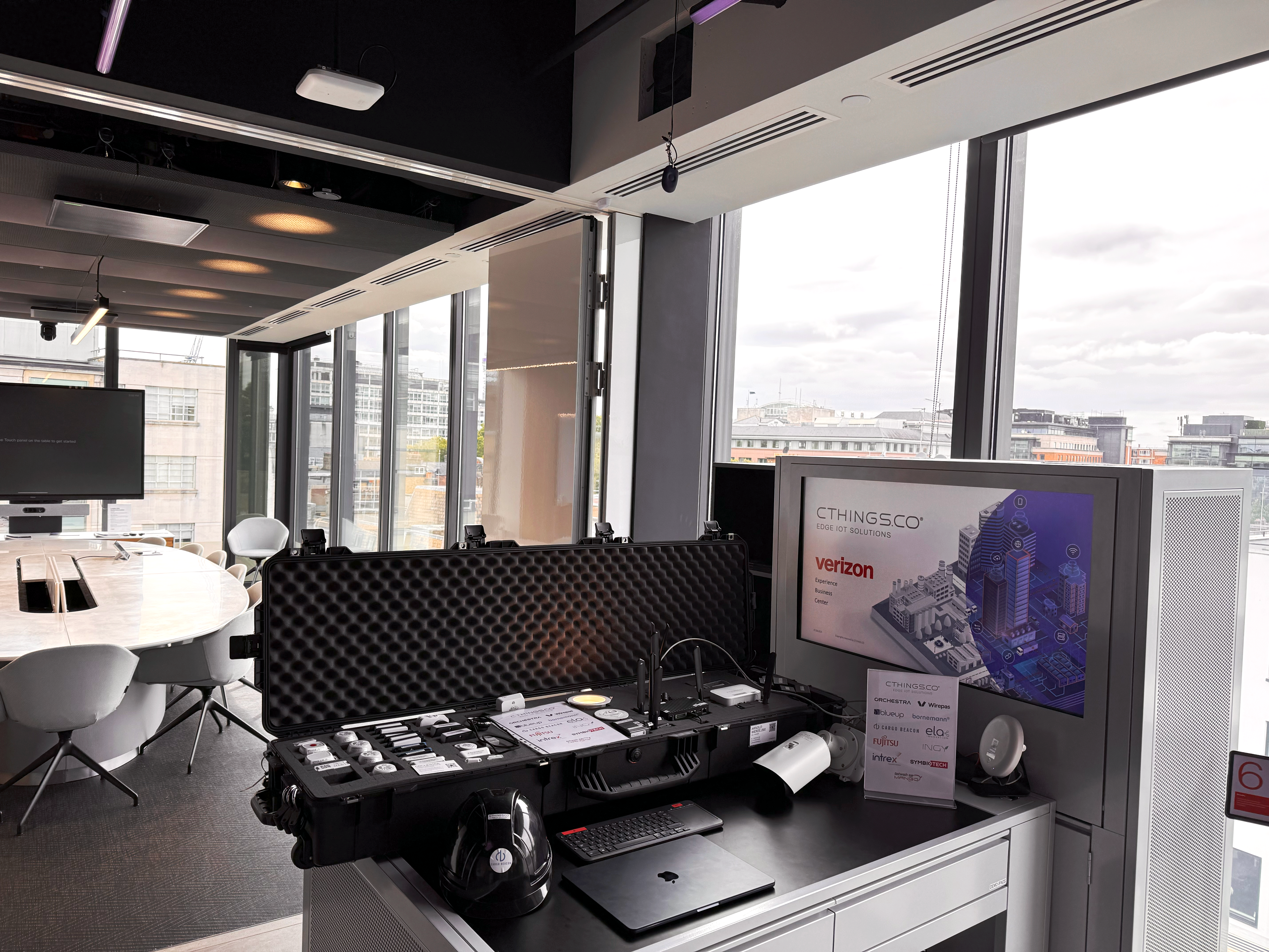 Conference room with a CTHINGS.CO suitcase equipped with Edge IoT Gateways, Wirepas IoT sensors and AI-enabled IoT management platform from CTHINGS.CO - Orchestra.